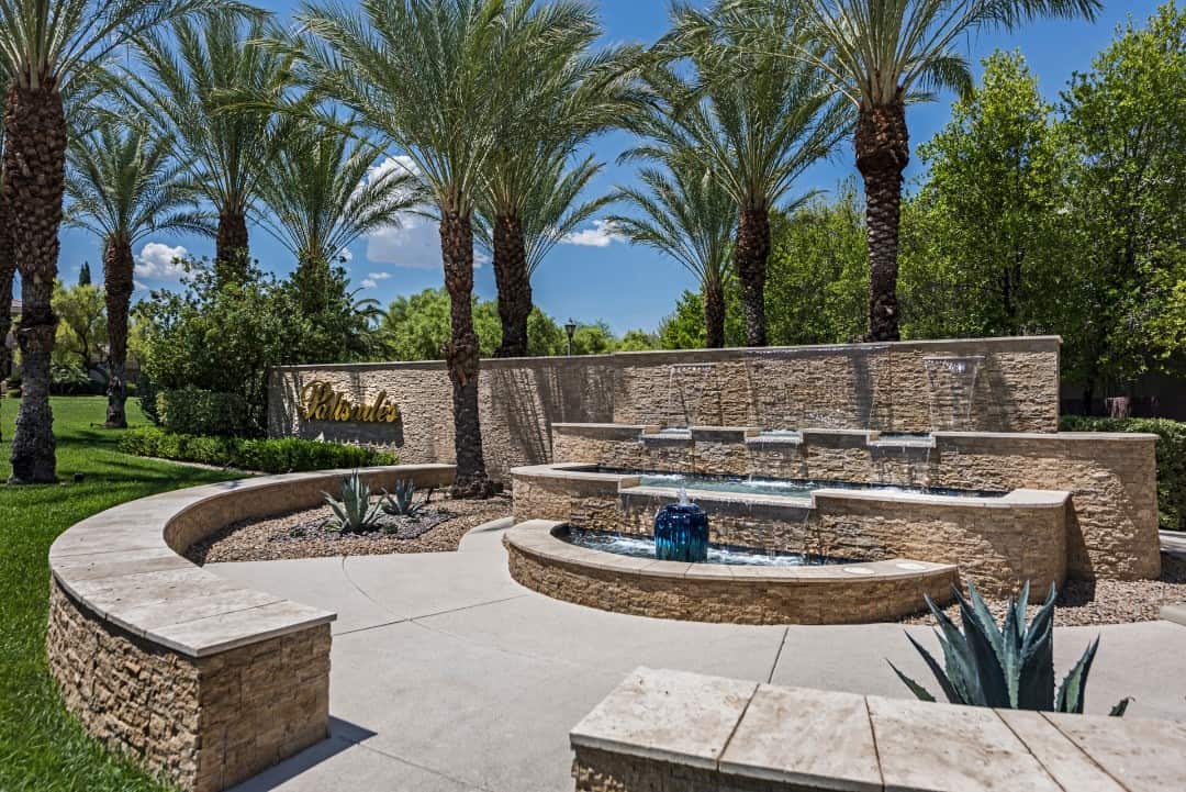 As you enter the community, you're greeted by water features and swaying palms.
